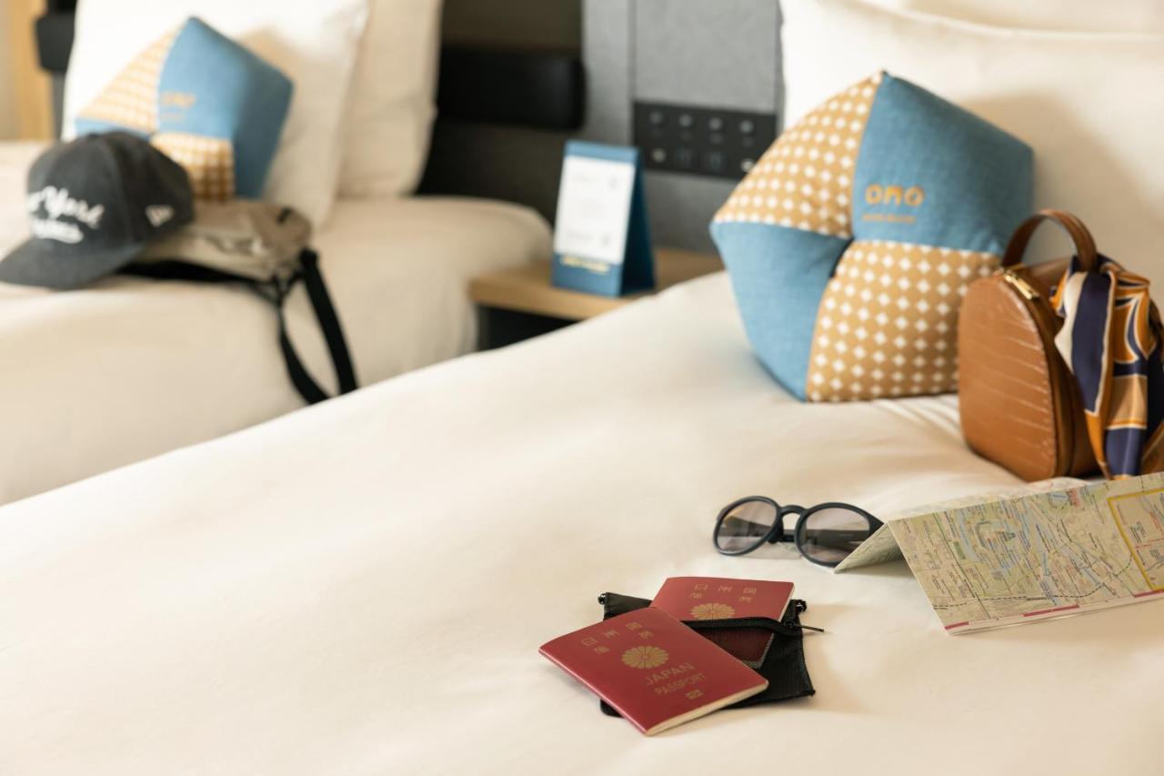 Omo Kansai Airport By Hoshino Resorts Идзумисано Экстерьер фото A passport and a boarding pass on a bed